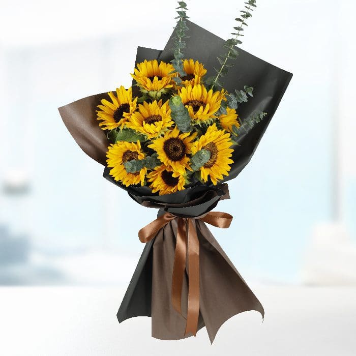 bt_fl_1079.png A bouquet of 10 sunflowers wrapped in black paper with a brown ribbon.