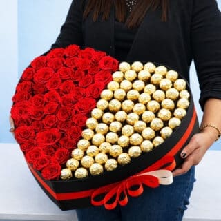 A woman holds a heart-shaped box filled with Ferrero chocolates and by 50 red roses, symbolizing love and affection.
