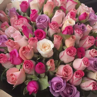 An eye-catching bouquet of mixed roses featuring a rustic brown wrap.