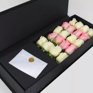 Charming pink and white roses arrangement in a rectangular black box.