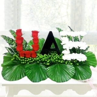 UAE is written using red, black, white and green flowers and leaves