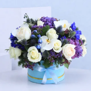 A blue flower box filled with a vibrant mix of exotic flowers, showcasing their beauty and bold colors.