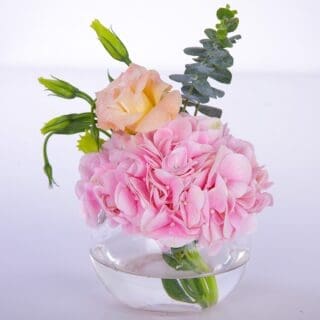Pink centerpiece flower arrangement consists of Hydrangeas, Lisianthus and Eucalyptus