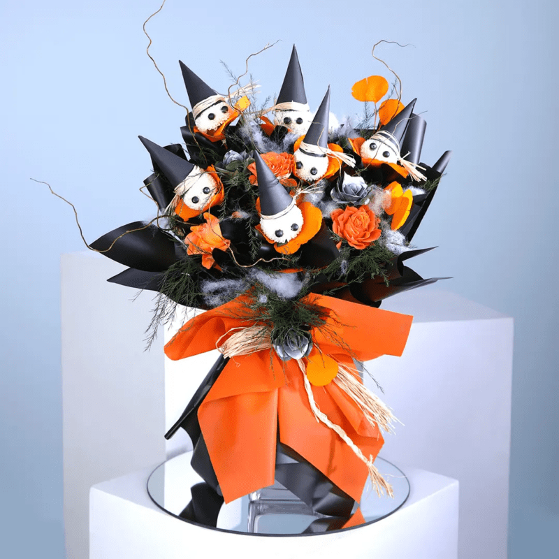 An eye-catching bouquet of bright orange roses combined with whimsical six ping pong accents to celebrate the spirit of Halloween.