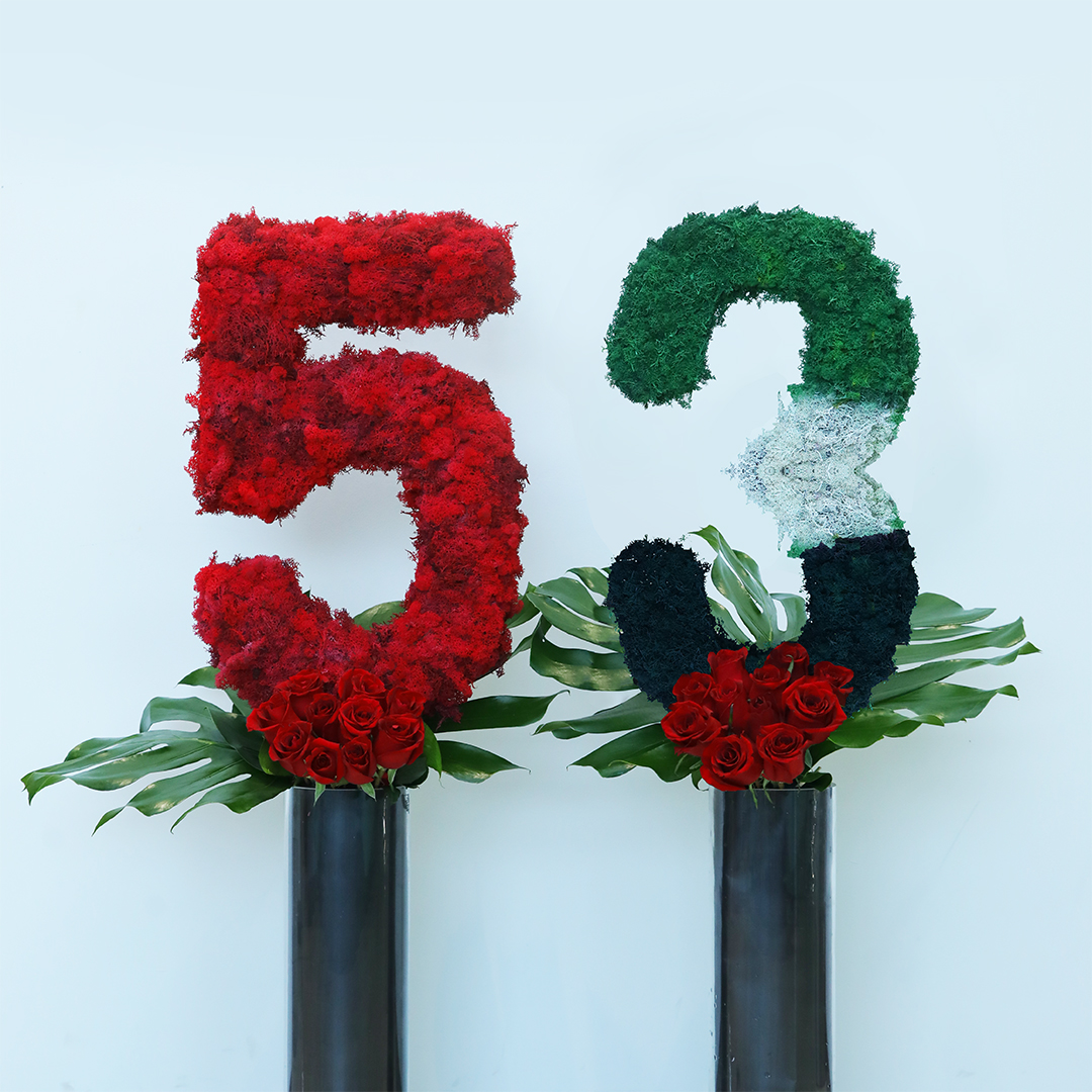The number 53 UAE national day creation using flag color flowers