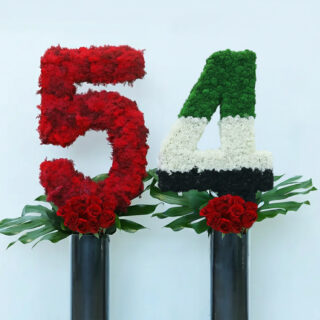 he number 54th UAE national day creation using flag color flowers