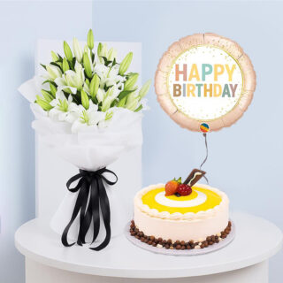 Birthday surprise: white Lilly bouquet, butterscotch cake, and balloon.