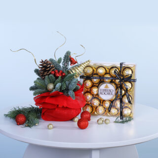 A festive floral arrangement paired with Ferrero Rocher chocolates, embodying the spirit of Christmas in a delightful treat.