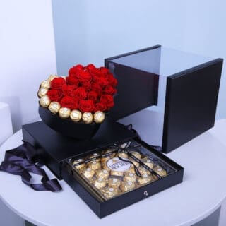 Red roses and Ferrero chocolates arranged in a heart-shaped black box, with an extra Ferrero box.