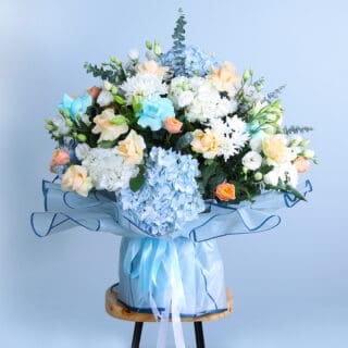 BTF Home 61 colorful bouquet of blue and white hydrangeas with peach roses, blue roses, and chrysanthemums on a wooden stool