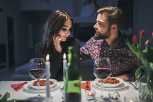 A Must-Have Valentine's Day Guide 2025: Everything You Need 4 A couple sharing a romantic dinner at home, adorned with elegant tableware, surrounded by candlelight, and a romantic ambiance for a cozy evening.