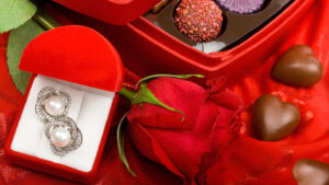 A Must-Have Valentine's Day Guide 2025: Everything You Need 7 Beautiful Traditional Valentine's Day gifts consisting of a Dazzling earring piece, a lavish red rose, and some heart-shaped Choco treats.