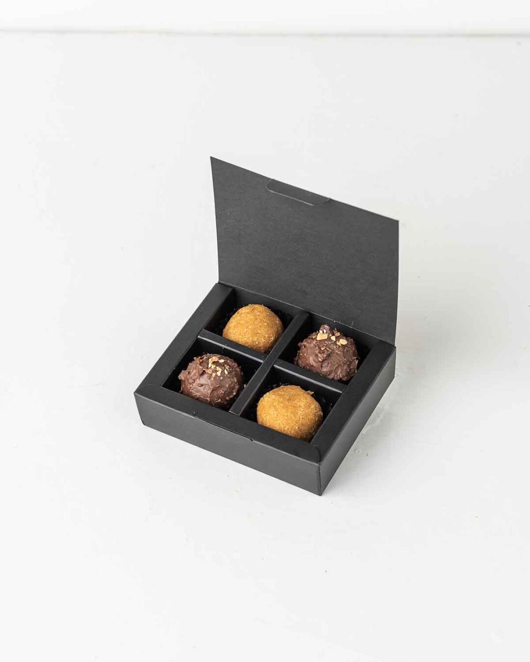 Mini Diwali Treat square gift box with besan laddus and milk chocolate truffles.