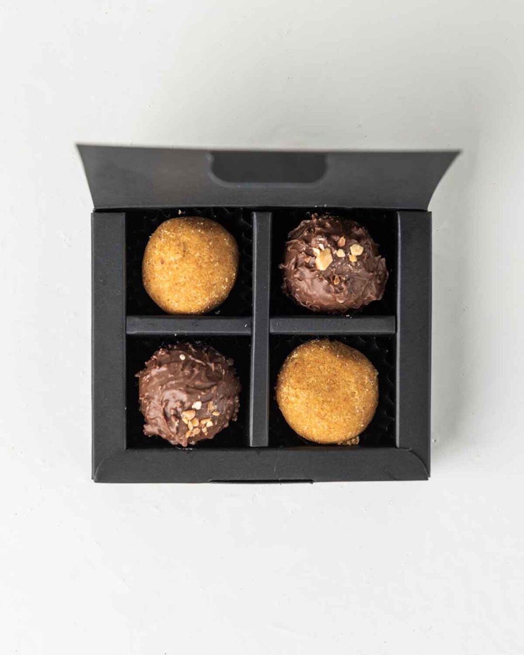 Mini Diwali Treat square gift box with besan laddus and milk chocolate truffles.