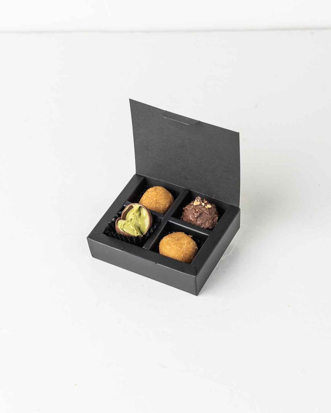 Mini Diwali Treat square gift box with besan laddus and milk chocolate truffles.