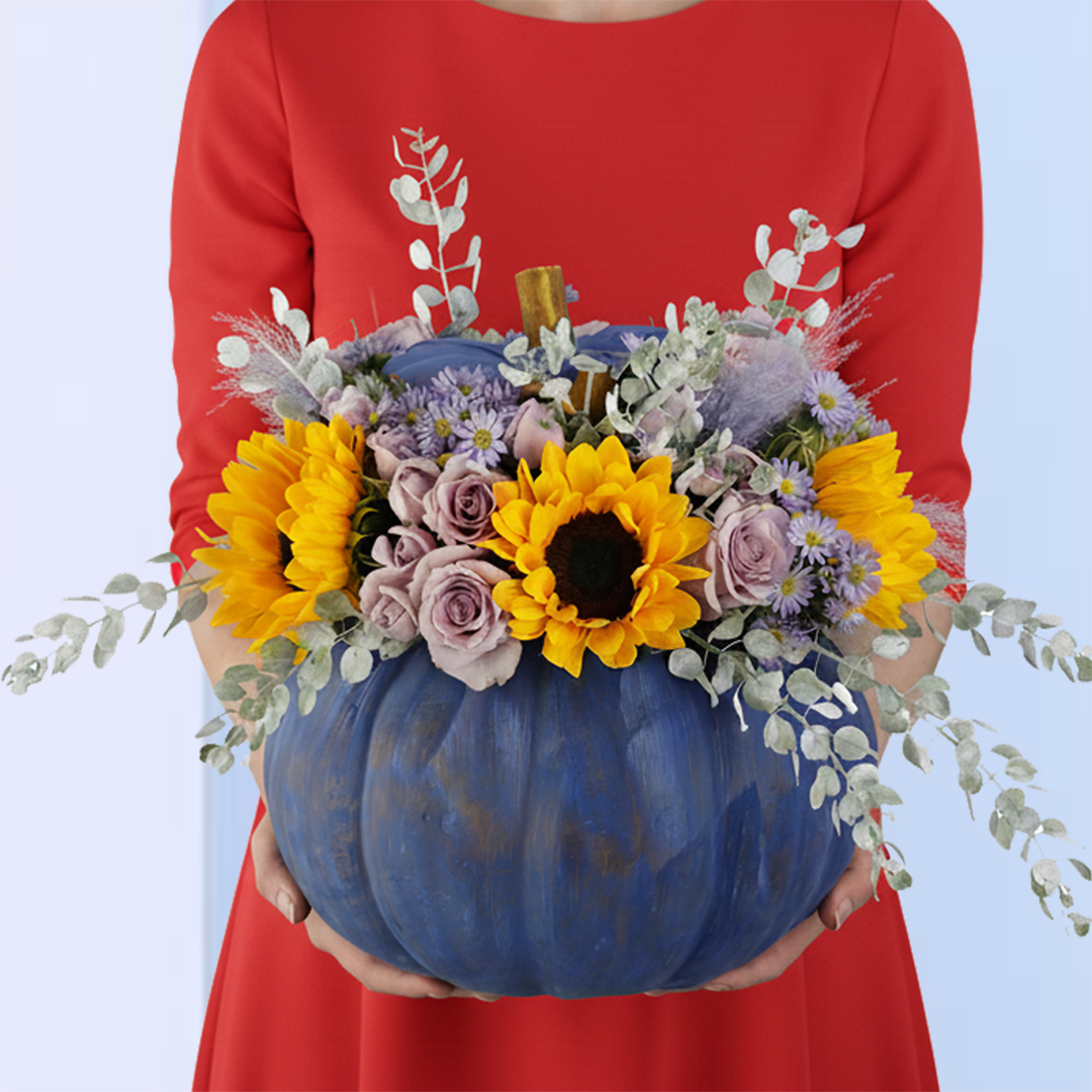 Sunny-Sunflower-Pumpkin-Surprise-25 A stunning pumpkin-shaped floral arrangement is the perfect way to add a touch of Halloween to your home or office. This arrangement, featuring sunflowers, pink roses, and other autumnal blooms, is sure to bring warmth and joy to any space.