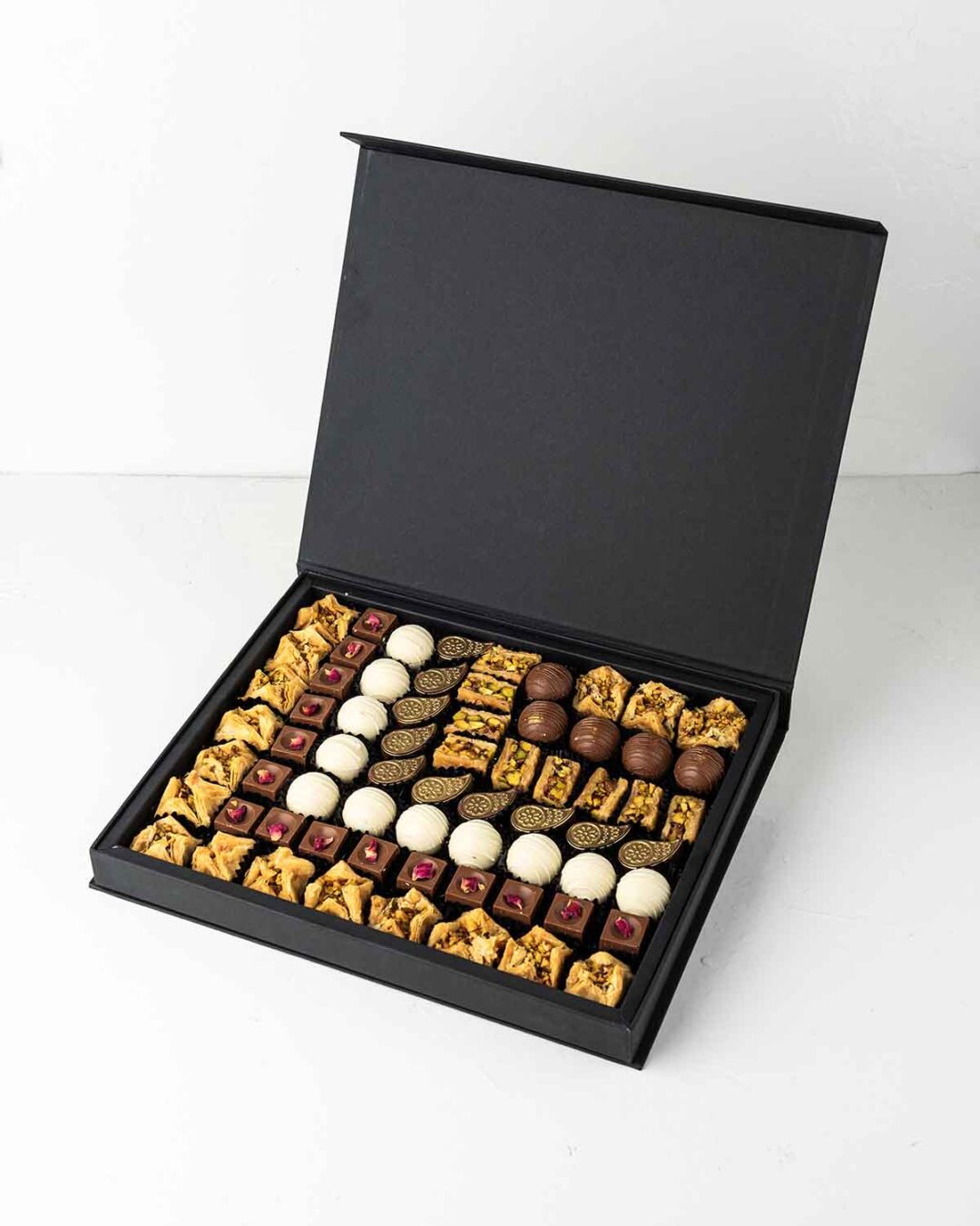 Diwali gift box featuring truffles, baklawa, and assorted chocolates in flavours like pistachio, hazelnut, and peanut butter.