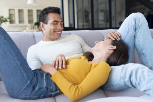Valentine's Day Gift Ideas for Every Relationship ( 25 ideas) 4 A happy couple enjoying a relaxing moment together on a sofa