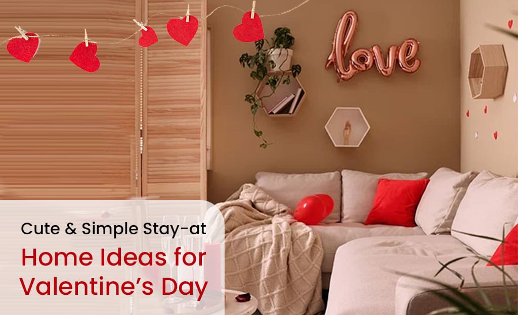 A cozy living room decorated for Valentine's Day. There is a sofa with red pillows, a string of heart-shaped decorations, a "Love" balloon, and other Valentine's Day decor. The text "Cute & Simple Stay-at-Home Ideas for Valentine's Day" is also included.
