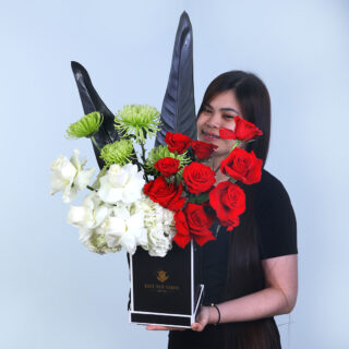 UAE National Day flower box with hydrangeas, roses, delistar greens, and fresh leaves, designed for easy carrying.