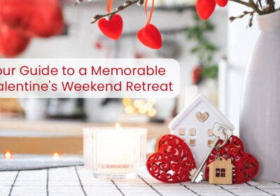 Your Guide to a Memorable Valentine's Weekend Retreat 6 A Valentine's Day themed image with a candle, decorative hearts, a small house figurine, and keys. The text "Your Guide to a Memorable Valentine's Weekend Retreat" is displayed above the image