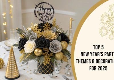 A festive New Year's Eve table setting with a centerpiece featuring black and gold flowers, ornaments, and a "Happy New Year 2025" sign. Golden party hats and confetti complete the festive look. The text "Top 5 New Year's Party Themes & Decorations for 2025" is overlaid on the image.