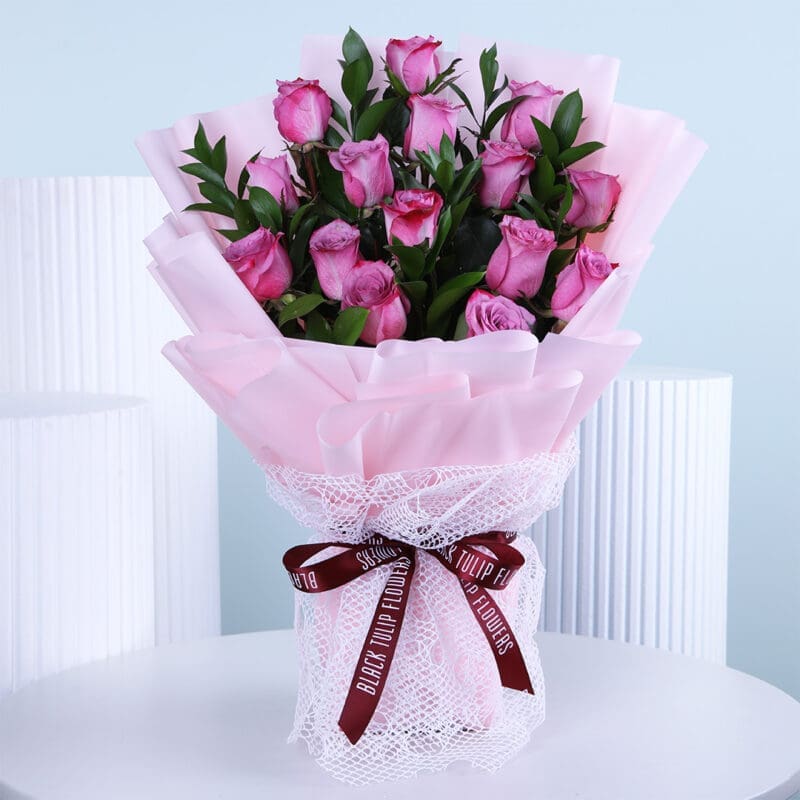 Hand-tied bouquet of roses and greenery, elegantly arranged for Women's Day.