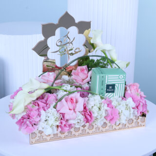 Eid flower arrangement with pink and white hydrangeas, pink Ohara roses, calla lilies, fresh green trachelium, and Patchi chocolates with "Eid Mubarak" wishes.