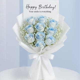 A vibrant bouquet of blue roses arranged for a happy birthday celebration