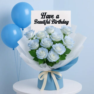 A beautiful bouquet of light blue roses, wrapped in white and blue paper, on a white table with three blue balloons.