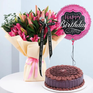 A birthday combo featuring a bouquet of pink lily flowers wrapped in light yellow wrap with a pink ribbon, a round pink "Happy Birthday" balloon and a round chocolate cake with chocolate frosting.
