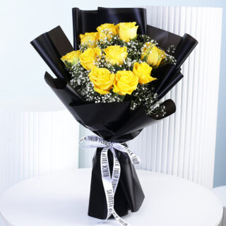 Bright yellow roses paired with delicate gypsophila, wrapped in deep black and finished with a chic monochrome ribbon.