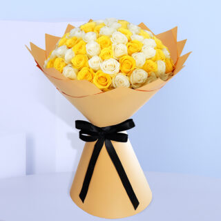 Bouquet of fresh white and yellow roses wrapped in golden brown and tied with a black ribbon.