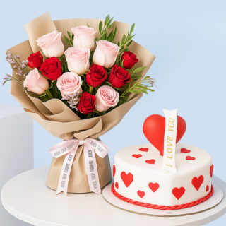 A romantic combo featuring a bouquet of red and light pink roses wrapped in brown and a white, square cake decorated with red hearts and a red heart topper with a "I LOVE YOU" banner.
