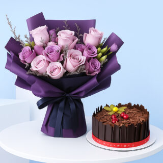A bouquet of light pink and purple roses wrapped in purple and gray, with a chocolate cake decorated with chocolate and cherries.