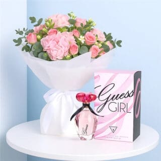 BTF Home 23 A Guess Girl EDT for Women with a White-wrapped bouquet of blush hydrangea, pink spray roses, and greenery on a table.
