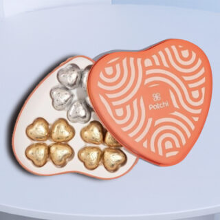 Patchi heart chocolate gift box featuring milk and dark heart-shaped chocolates, presented in a red tin.