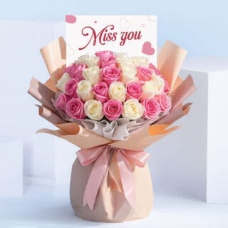 BTF Home 44 Miss You bouquet featuring pink and white roses hand-tied in blush wrapping with a satin ribbon and “Miss You” card.