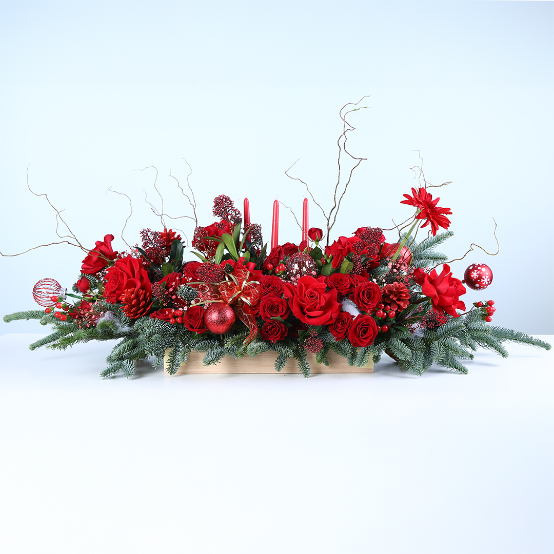 christmas-candle-flower-tray Christmas candle tray with red anthuriums, red roses, Nobilis leaves, and Brown sticks in a wooden tray.