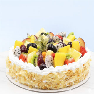 Fruit Cake 1 Kg by Mister Baker topped with fresh seasonal fruits and almond flakes
