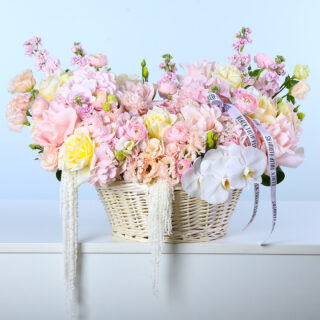 Pastel rose, hydrangea, lisianthus, mattiola, ranunculus, amaranthus and orchid flower basket arrangement