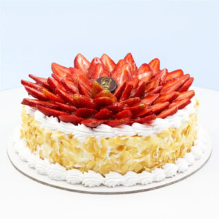Strawberry Cream Cake 1 Kg by Mister Baker topped with fresh sliced strawberries and whipped cream.