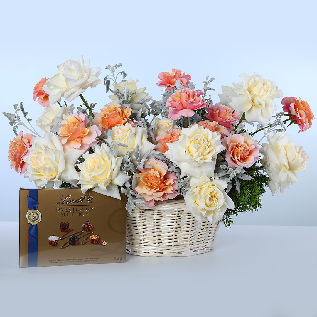 white-orange-roses-basket-with-lindt Basket of white and orange Ecuador roses with greenery and Lindt Swiss chocolates.