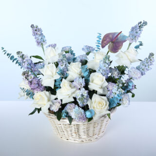 White rose, matthiola, carnation, eucalyptus and anthurium flower basket arrangement.