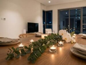 Eucalyptus and candle floral arrangement for a cozy, glowing New Year centerpiece.