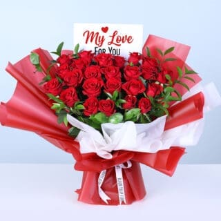 25 red roses and lush greenery in red wrapping, finished with a message card.