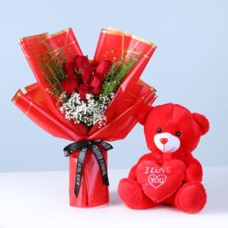 Flower Not Found 10 A bouquet of seven red roses with greenery and a red teddy bear, perfect for expressing love and affection.