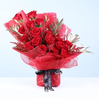 Red roses bouquet with gold accents in red wrap