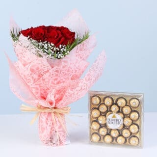 Red rose bouquet with white fillers and green foliage wrapped in pink paired with Ferrero Rocher chocolate box.