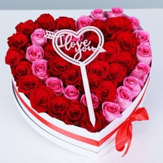 Red and pink roses in a heart box style with a red ribbon, finished with a “I love you” message.